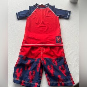 Adorable Gymboree boys crab swim trunks and matching rash guard shirt.